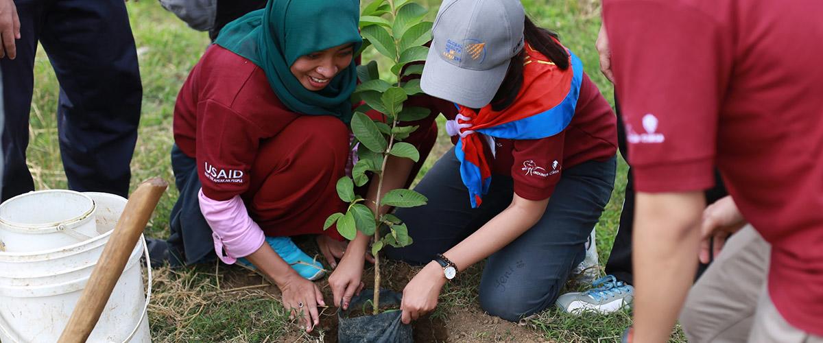 Two students plant a tree