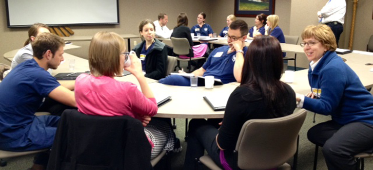 Students around a conference table at an IPE event in Willmar