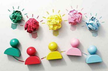 lightbulb figures made out of brightly colored paper