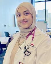 Headshot of Saliha Chaudhry, a female medical student, smiling at the camera.